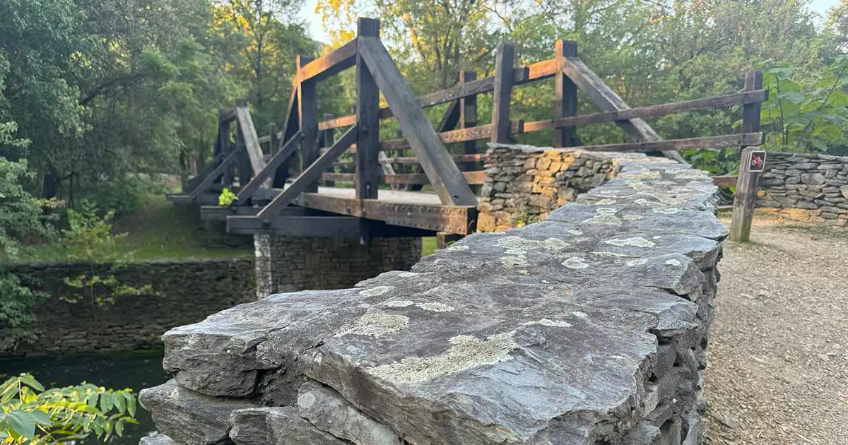 Harpers Ferry Virginius Island Bridge in Harpers Ferry. The bridge leads to the Virginius Island Trail, which passes through the Harpers Ferry historical industry sites and ruins on to other trails and areas in the park and town of Harpers Ferry.
